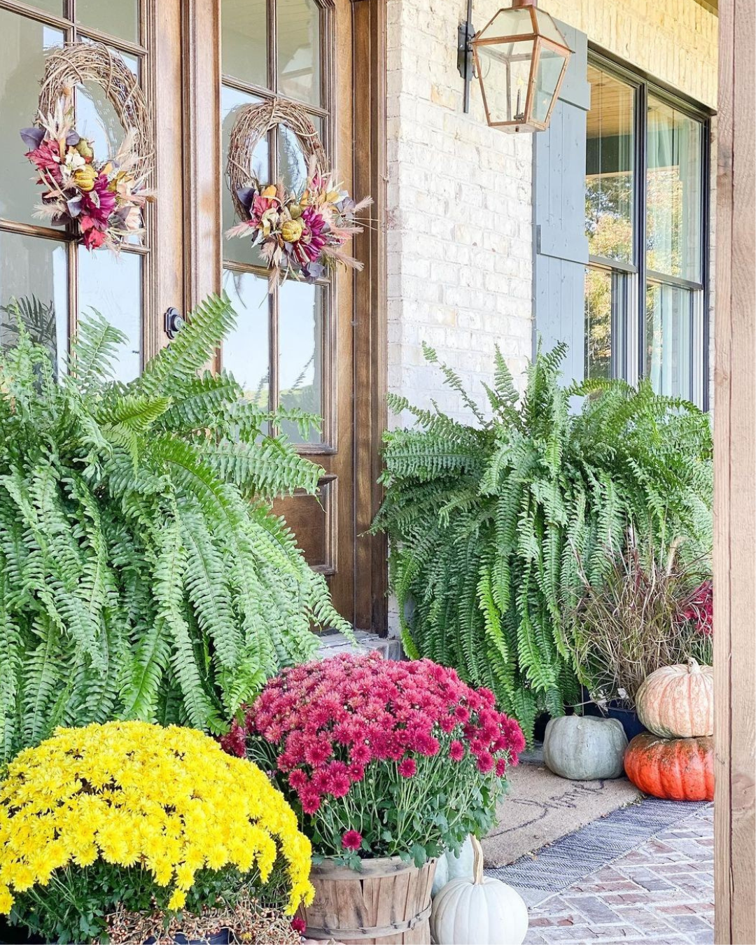 White brick home with red brick patio and colorful plants - North Georgia Brick