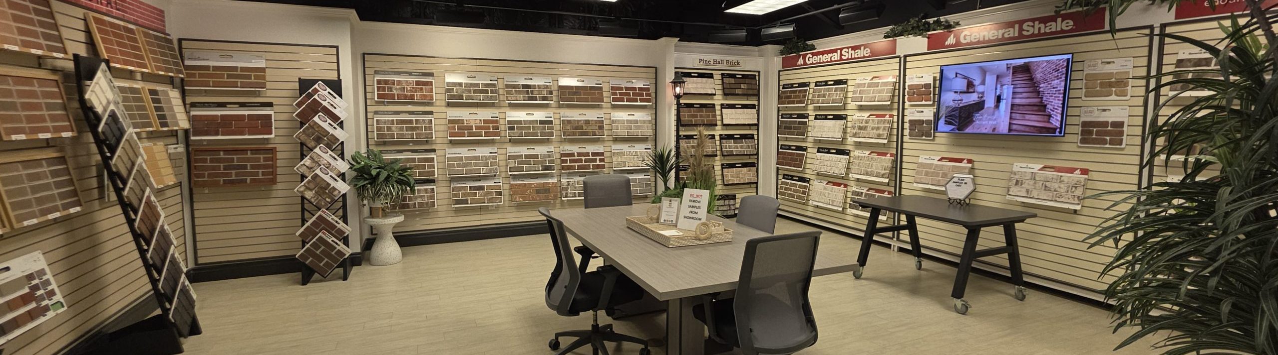 Interior view of North Georgia Brick Cumming Showroom with desk, office chairs and brick types