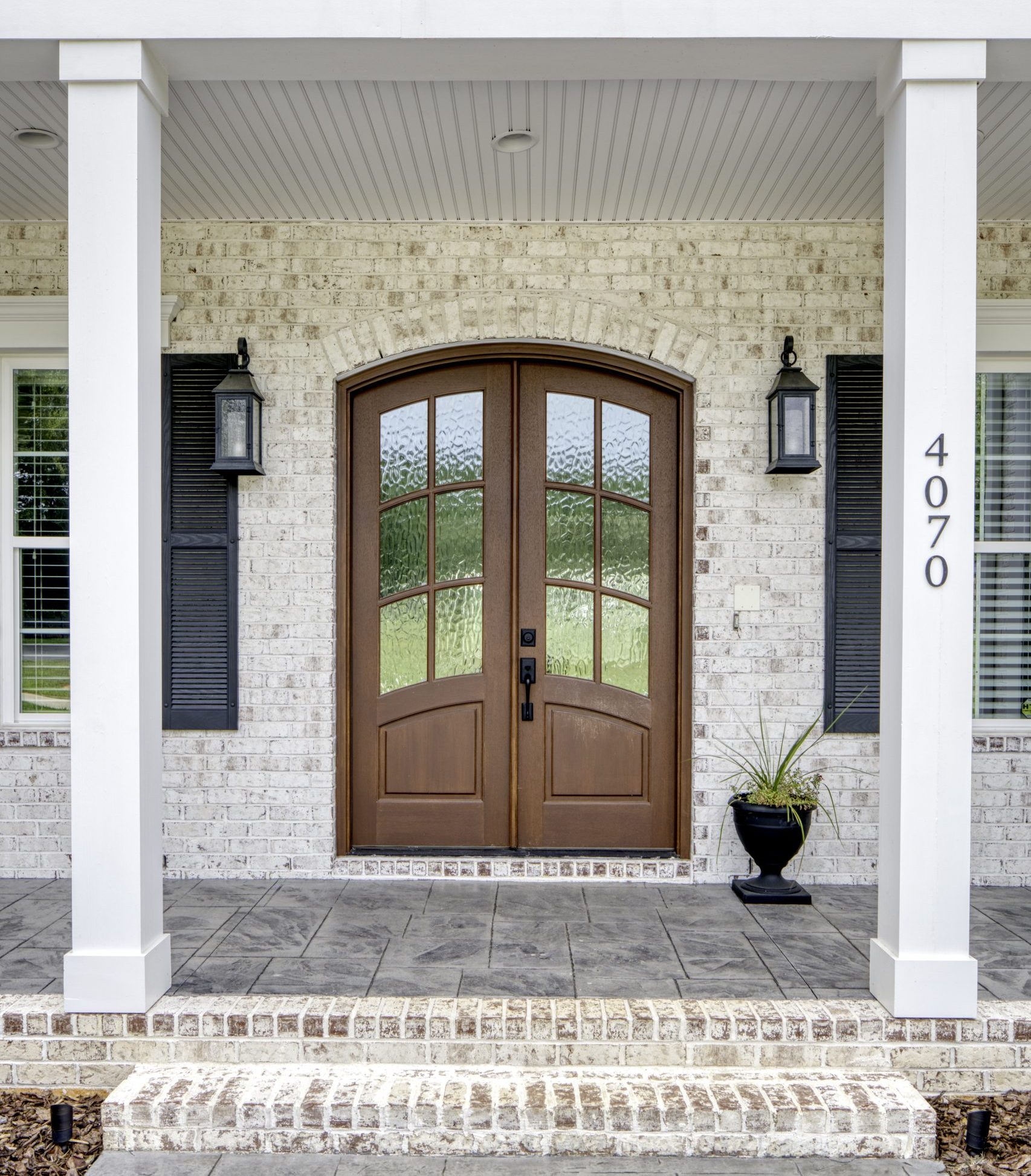 Brick entryway in white wash brick from North Georgia Brick,, showing the use of stretcher bricks for the arch and rowlock for the brick steps.
