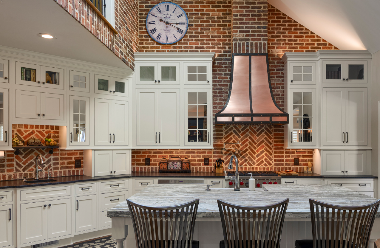 A kitchen featuring a thin brick backsplash paired with peppermill and English pub-style cabinetry from North Georgia Brick.