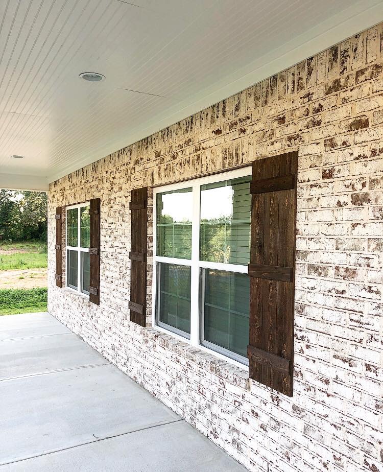 Close-up of Old Edisto brick with Savannah Ivory mortar and rustic brown shutters on a Southern home front porch.